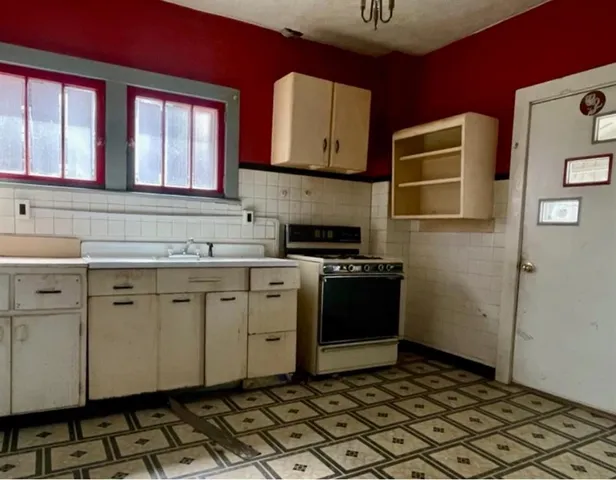 a kitchen with a refrigerator sink and cabinets