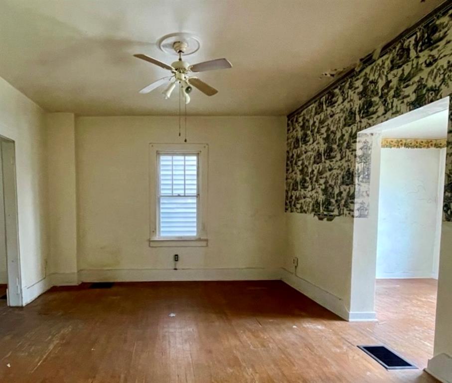 315 Spruce Street Vandergrift, PA 15690 - Photo 6 of 14 an empty room with wooden floor and windows