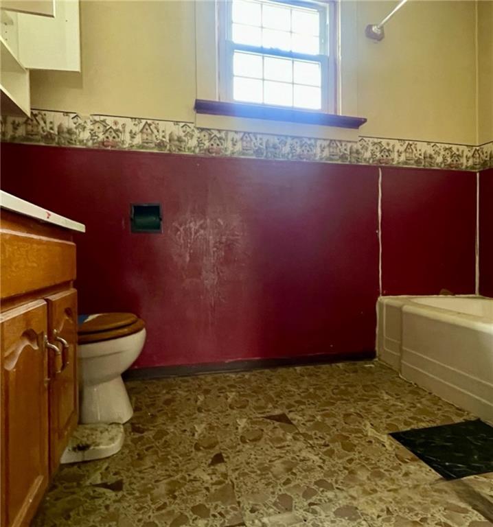 315 Spruce Street Vandergrift, PA 15690 - Photo 9 of 14 a bathroom with a granite countertop toilet and a sink