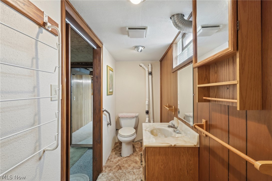 3873 Baumberger Road Stow, OH 44224 - Photo 37 of 50 Bathroom featuring vanity, toilet, and a textured ceiling