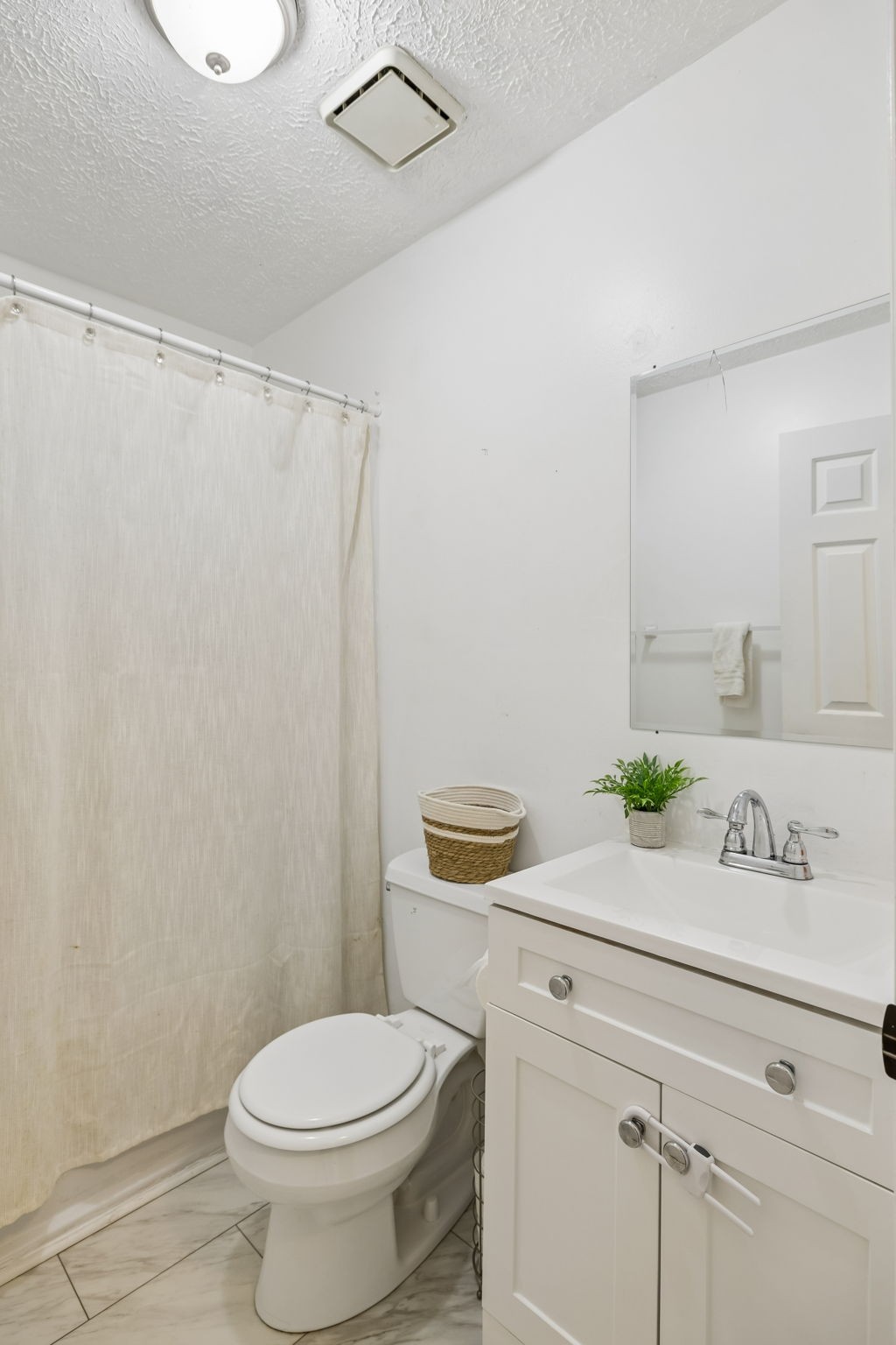 8617 Maple Street Murfreesboro, TN 37129 - Photo 17 of 31 a bathroom with a sink a toilet and a mirror