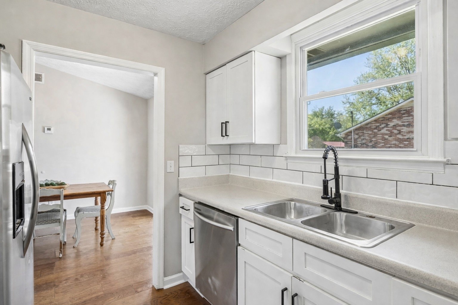 8617 Maple Street Murfreesboro, TN 37129 - Photo 23 of 31 a kitchen with a sink a table and chairs