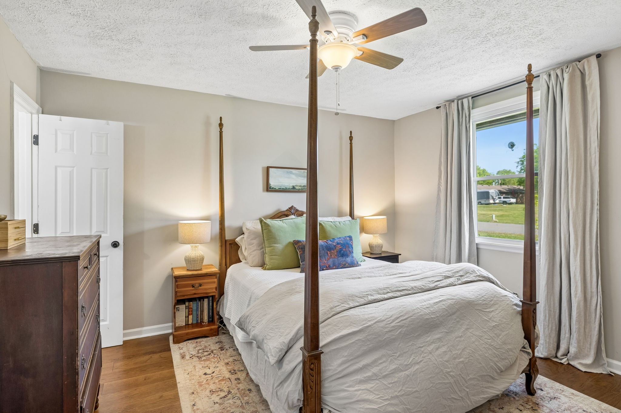 8617 Maple Street Murfreesboro, TN 37129 - Photo 10 of 31 a bedroom with a bed lamp and a dresser