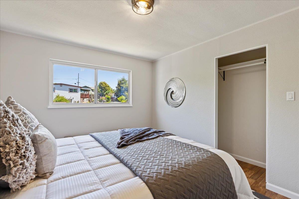 231 Pinole Avenue Rodeo, CA 94572 - Photo 11 of 26 a bedroom with a bed and painting on the wall