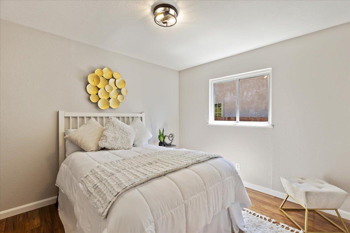 231 Pinole Avenue Rodeo, CA 94572 - Photo 12 of 26 a bedroom with a bed and painting on the wall