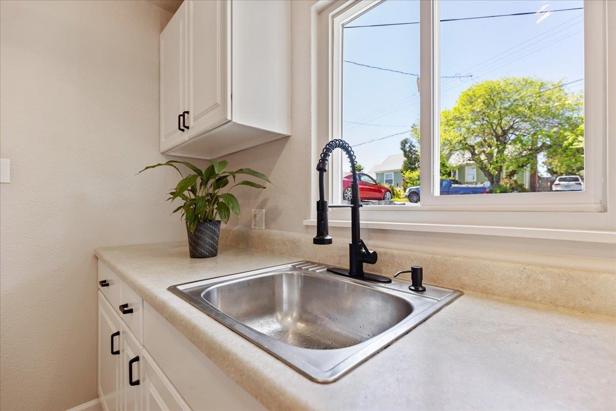 231 Pinole Avenue Rodeo, CA 94572 - Photo 14 of 26 a kitchen with a sink and a window