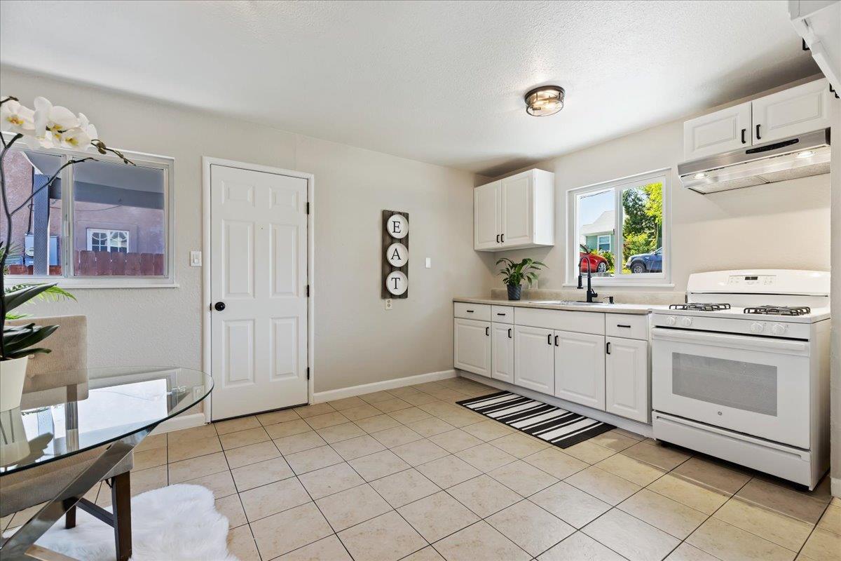 231 Pinole Avenue Rodeo, CA 94572 - Photo 7 of 26 a kitchen with a sink cabinets and window