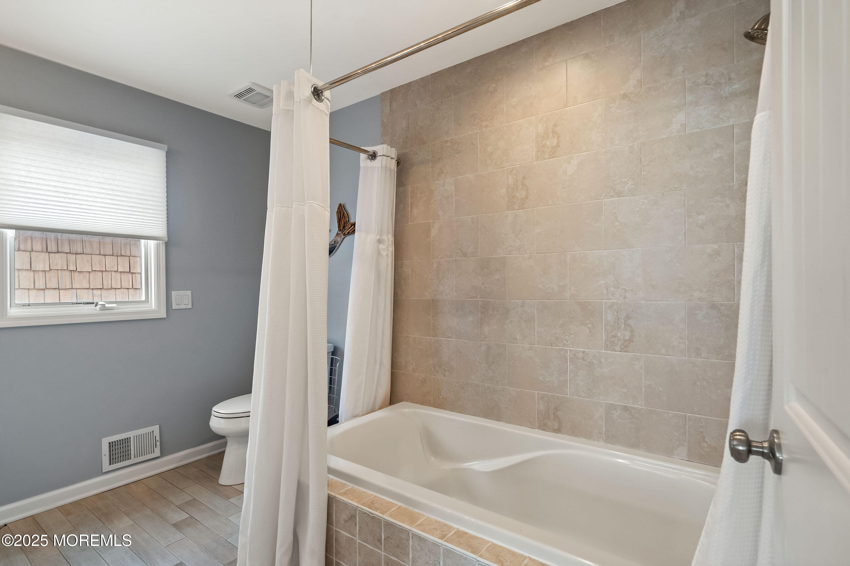 21 Magee Avenue Lavallette, NJ 08735 - Photo 16 of 25 a bathroom with a bathtub and a toilet