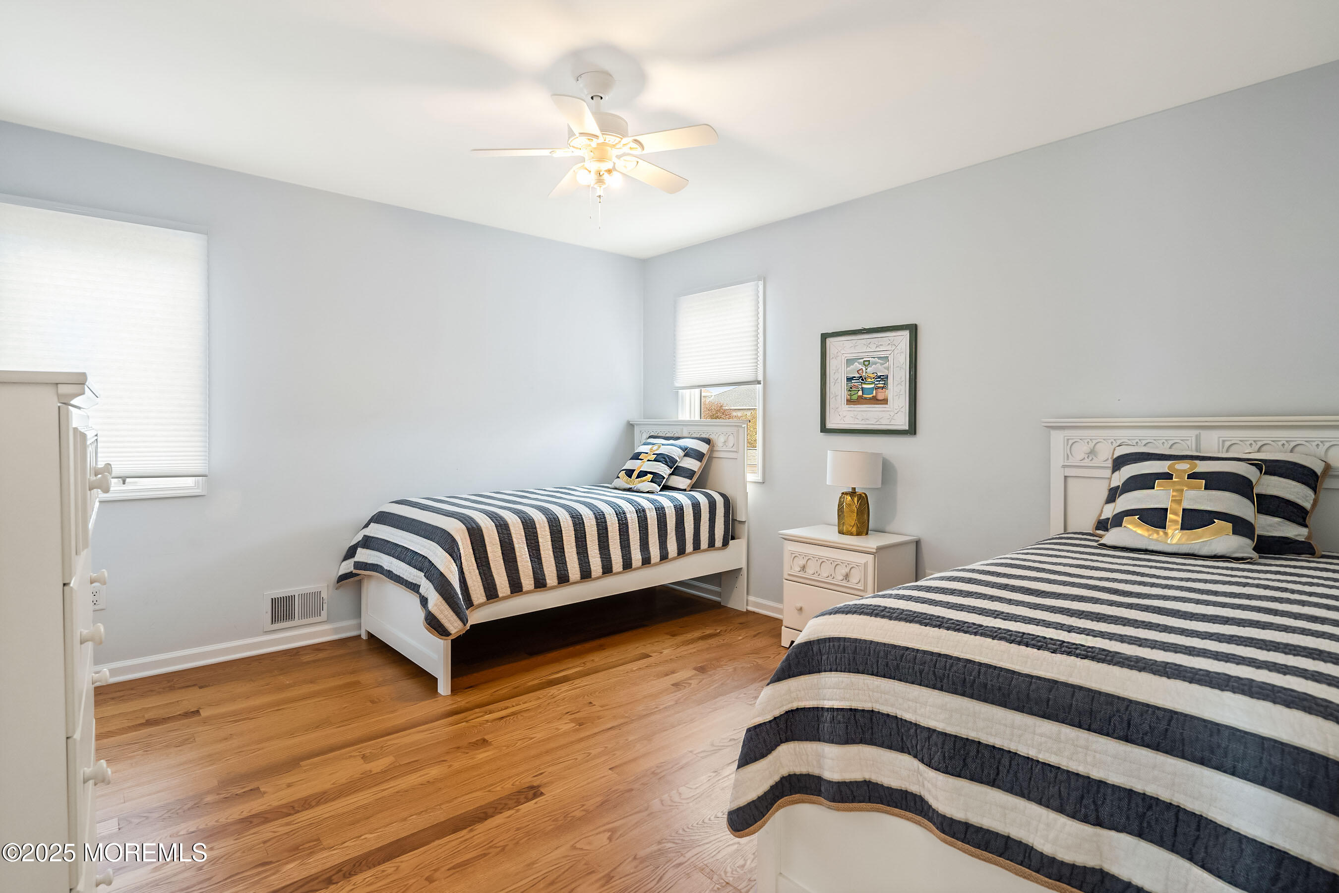 21 Magee Avenue Lavallette, NJ 08735 - Photo 18 of 25 a bedroom with a bed and wooden floor