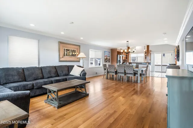 a living room with furniture and a painting on the wall