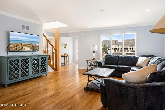 a view of a dining room with furniture wooden floor and a chandelier
