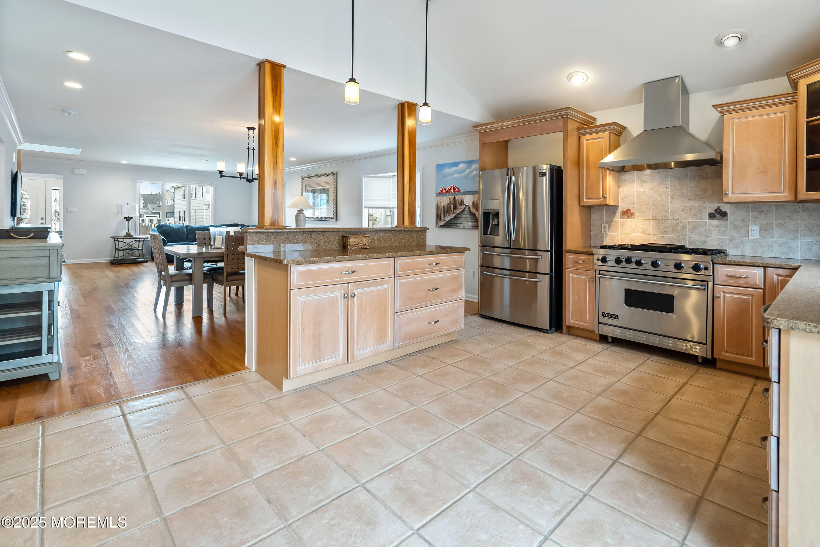 21 Magee Avenue Lavallette, NJ 08735 - Photo 10 of 25 a kitchen with stainless steel appliances a stove a sink a oven a dining table cabinets and chandelier