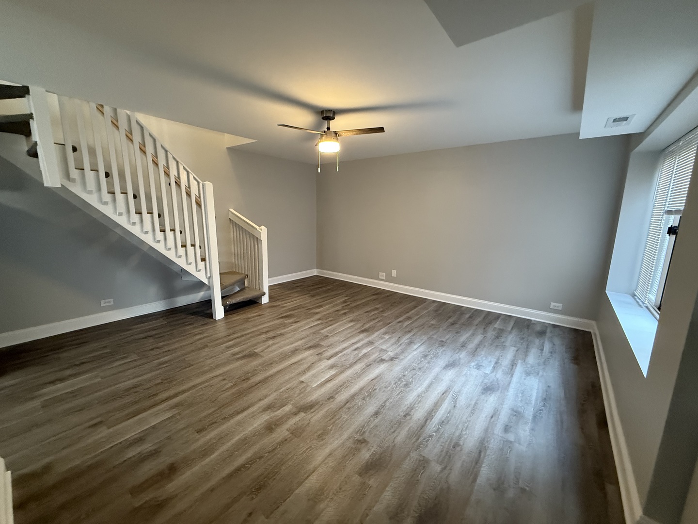 744 West Gordon Terrace, Unit 312 Chicago, IL 60613 - Photo 2 of 11 wooden floor in an empty room with a window