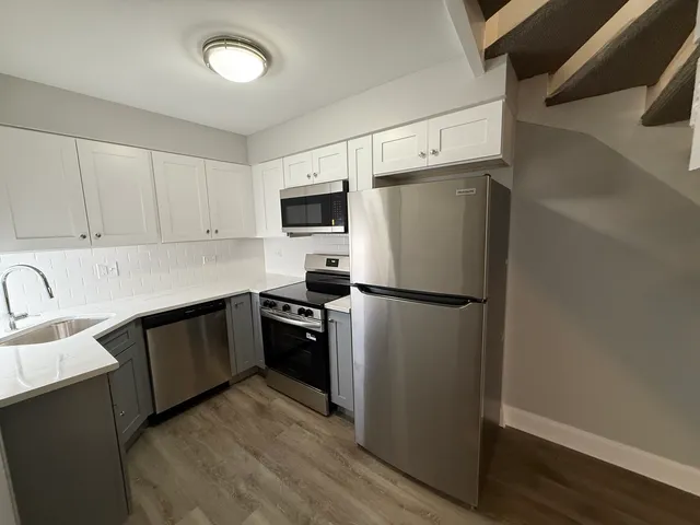 a kitchen with a refrigerator stove and sink