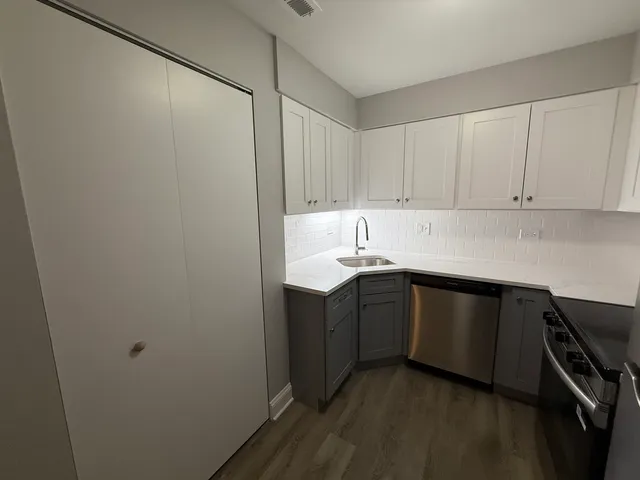 a kitchen with a sink and cabinets