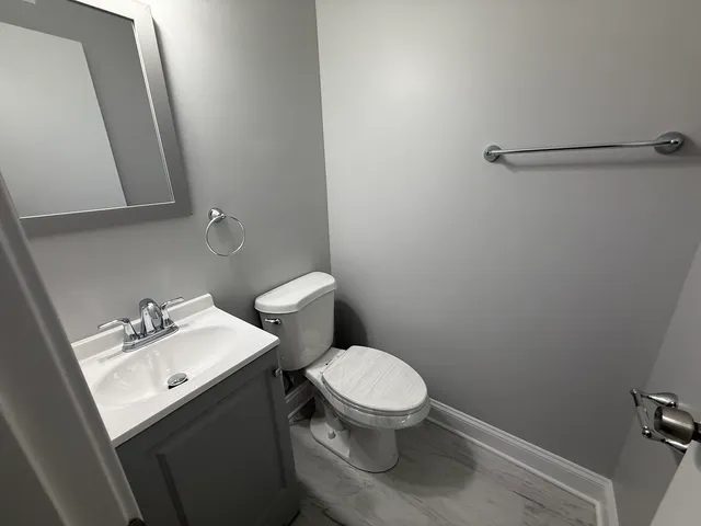 a white toilet sitting next to a bathroom sink