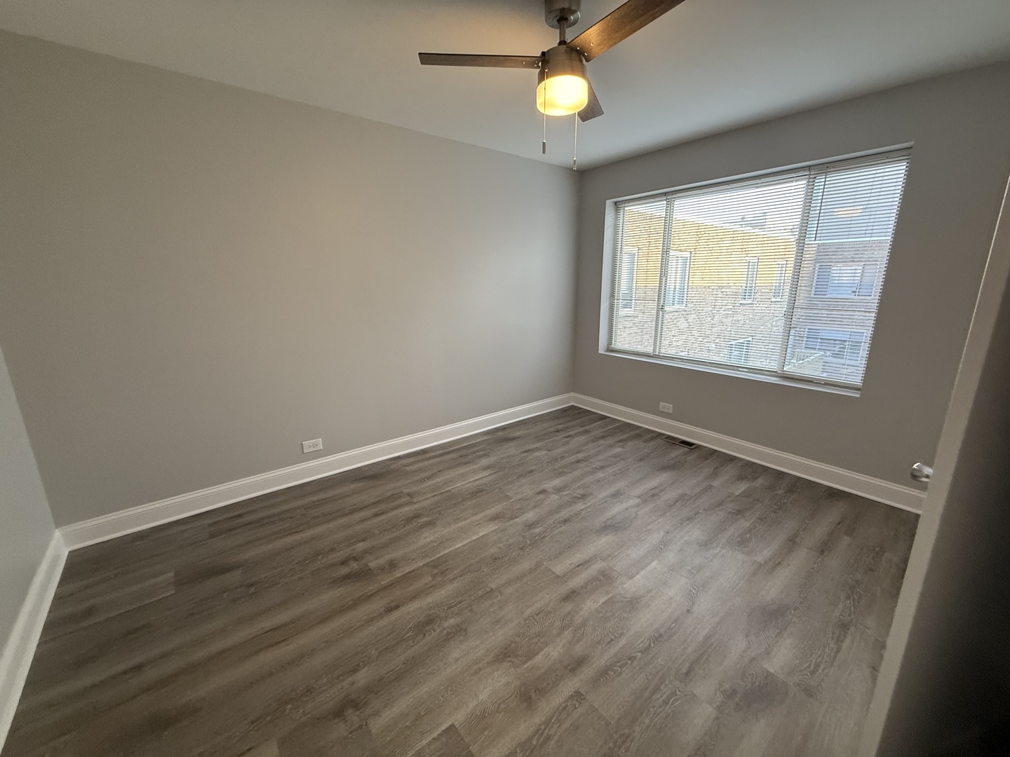 744 West Gordon Terrace, Unit 312 Chicago, IL 60613 - Photo 10 of 11 an empty room with wooden floor and windows