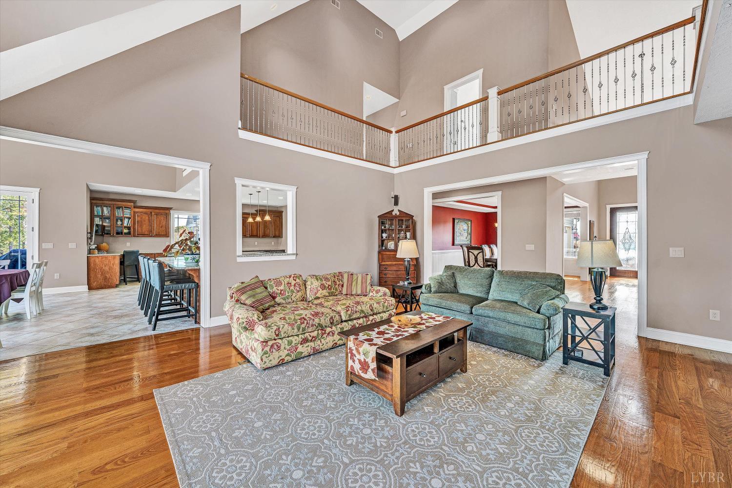 803 Compass Cove Circle Moneta, VA 24121 - Photo 21 of 92 a living room with fireplace furniture and a wooden floor