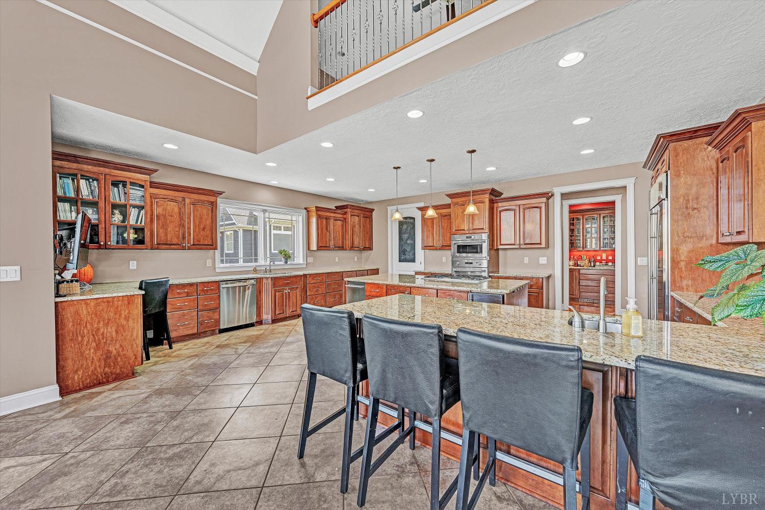 803 Compass Cove Circle Moneta, VA 24121 - Photo 22 of 92 a kitchen with stainless steel appliances granite countertop table chairs sink and cabinets