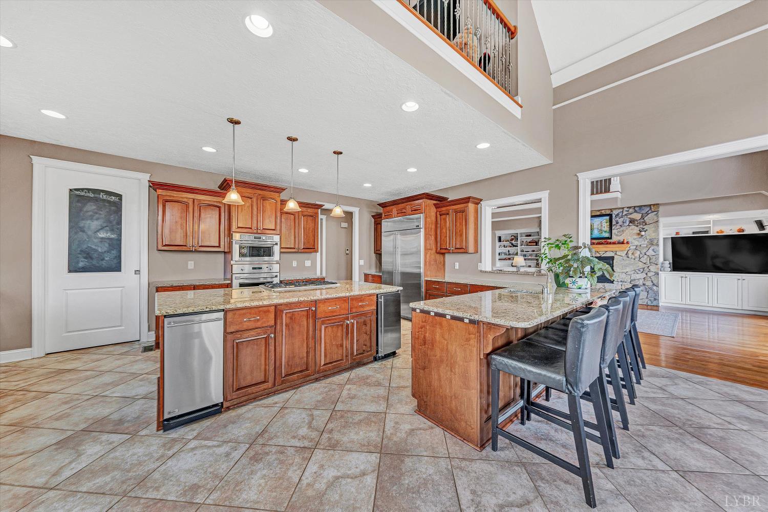 803 Compass Cove Circle Moneta, VA 24121 - Photo 25 of 92 a kitchen with stainless steel appliances granite countertop a table chairs sink and cabinets