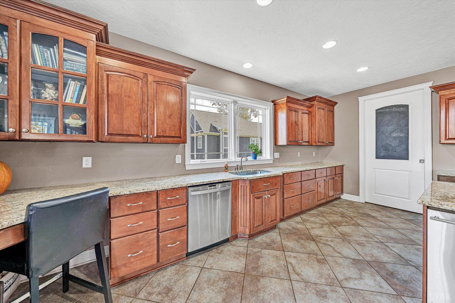 803 Compass Cove Circle Moneta, VA 24121 - Photo 26 of 92 a large kitchen with stainless steel appliances granite countertop a stove a sink and a microwave