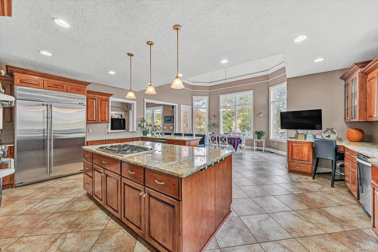 803 Compass Cove Circle Moneta, VA 24121 - Photo 27 of 92 a kitchen with stainless steel appliances granite countertop a stove and a kitchen island