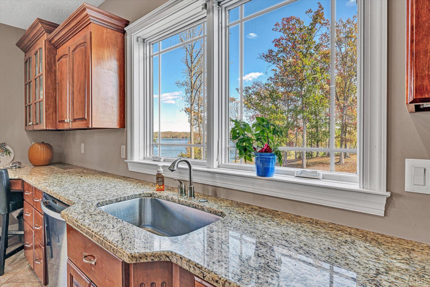 803 Compass Cove Circle Moneta, VA 24121 - Photo 28 of 92 a kitchen with a granite countertop sink and natural light