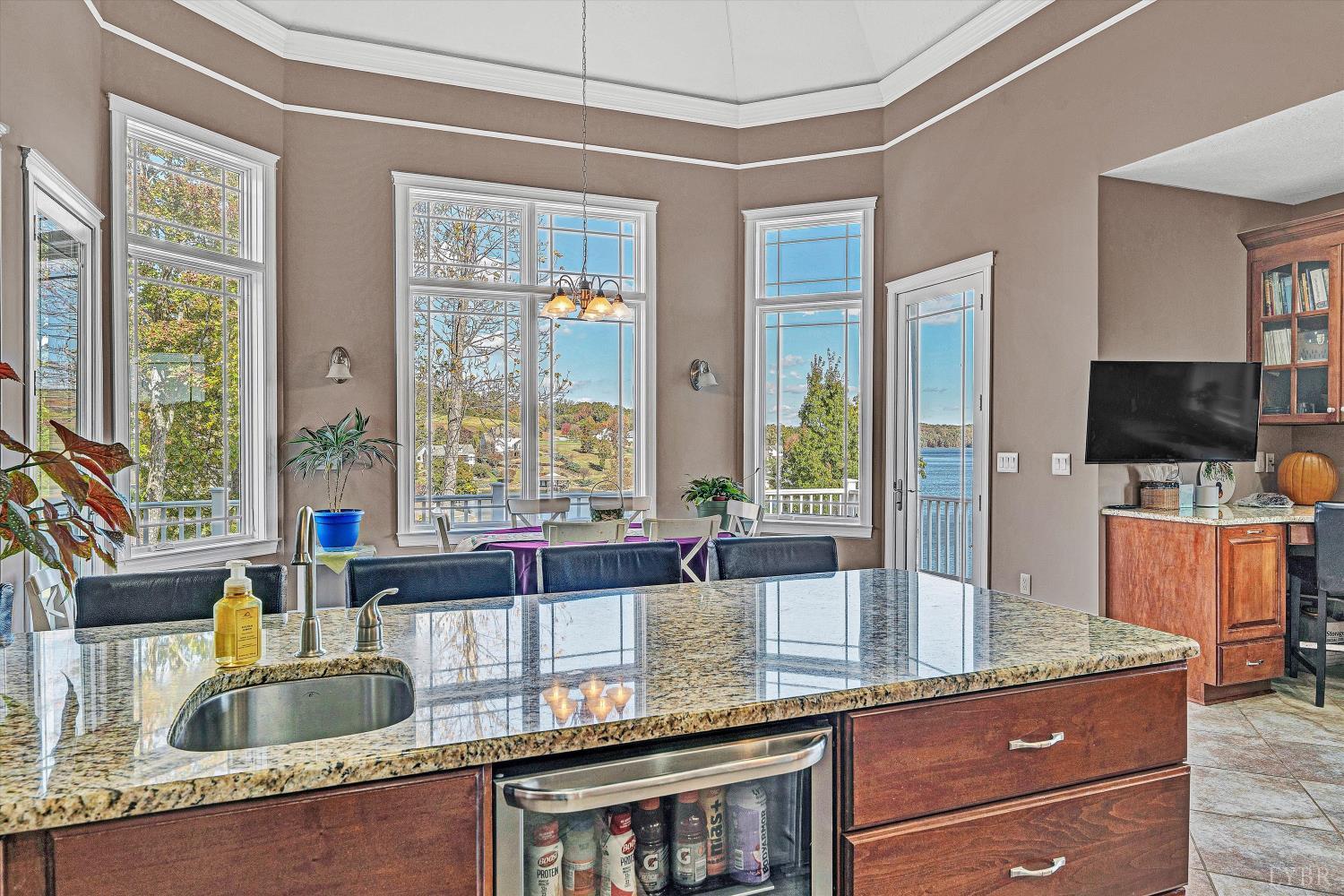 803 Compass Cove Circle Moneta, VA 24121 - Photo 29 of 92 a kitchen with granite countertop a sink and a counter top space