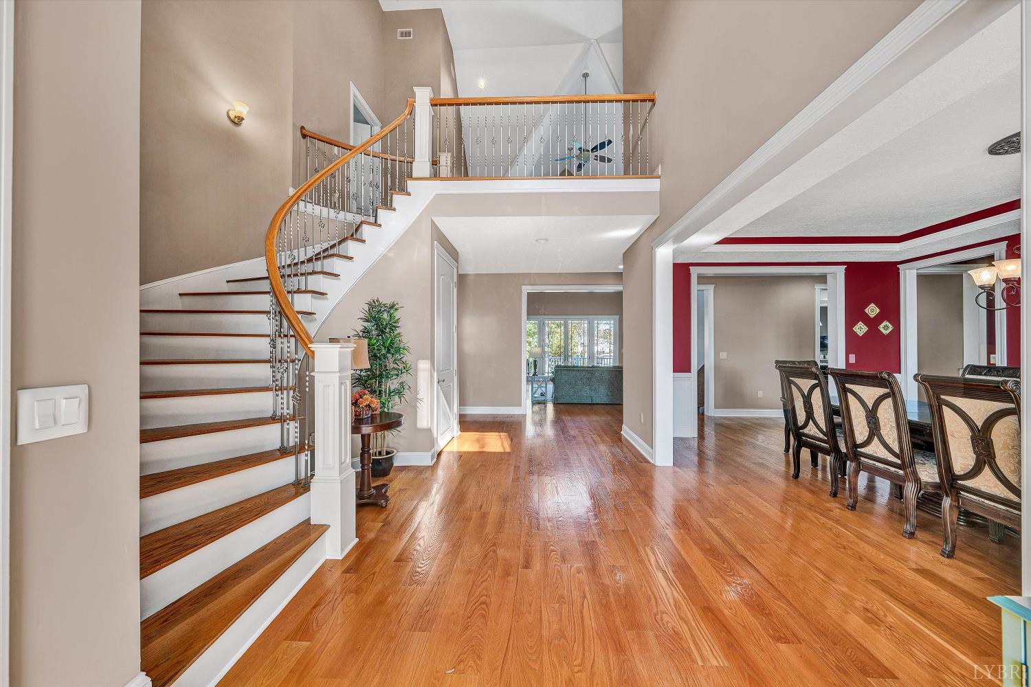 803 Compass Cove Circle Moneta, VA 24121 - Photo 4 of 92 a view of a hallway with wooden floor table and chairs