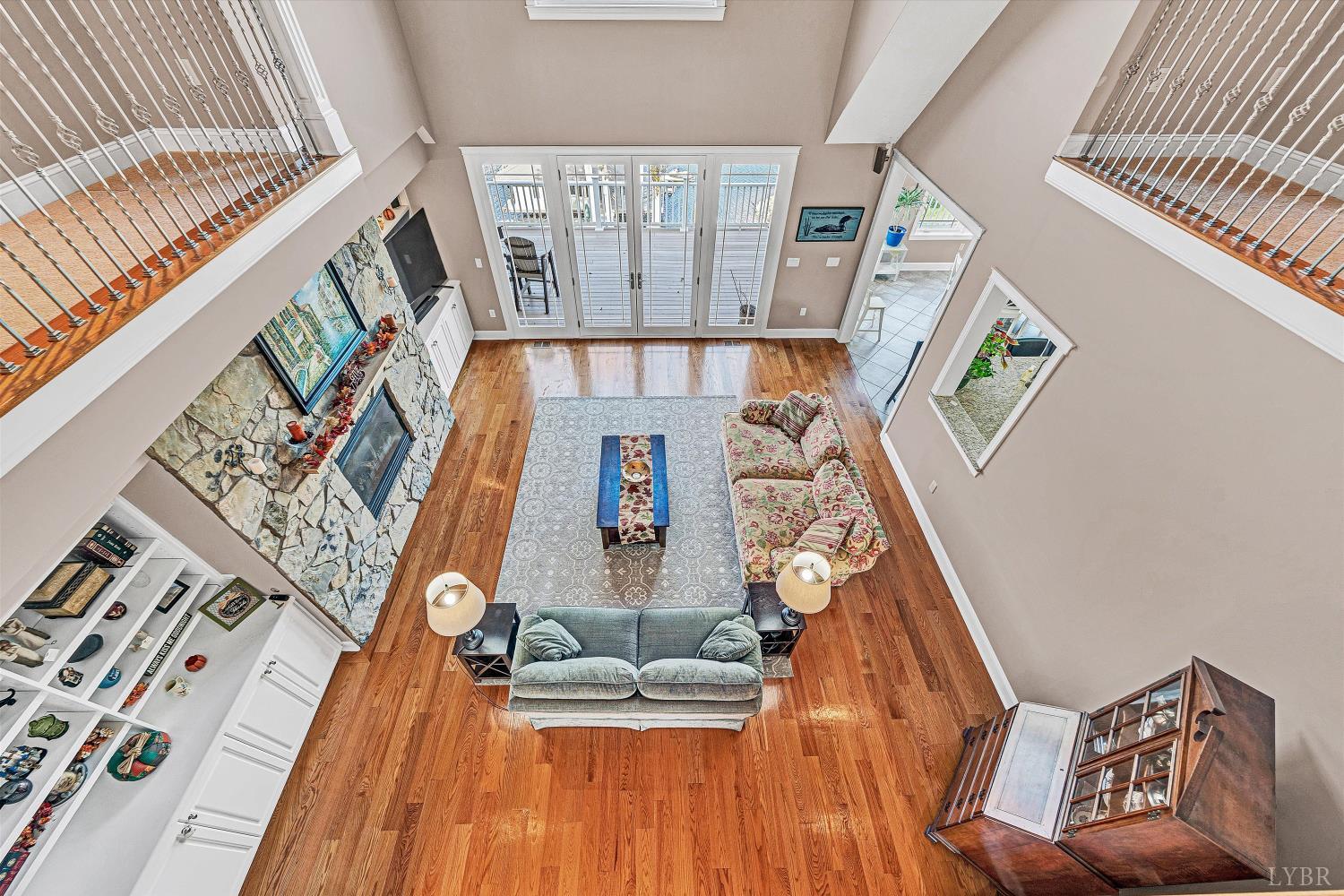 803 Compass Cove Circle Moneta, VA 24121 - Photo 45 of 92 a living room with furniture and a floor to ceiling window