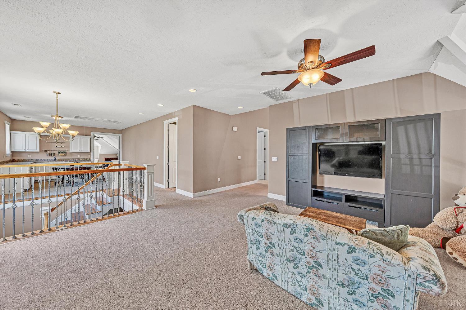 803 Compass Cove Circle Moneta, VA 24121 - Photo 47 of 92 a living room with furniture and a flat screen tv