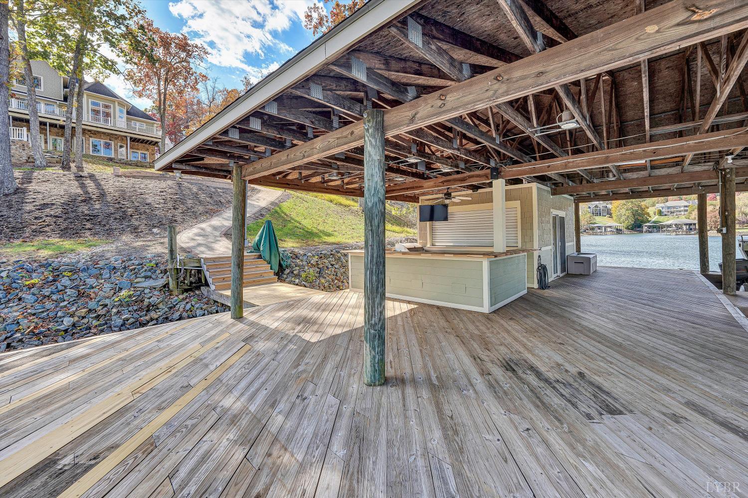 803 Compass Cove Circle Moneta, VA 24121 - Photo 72 of 92 a view of a porch with wooden floor