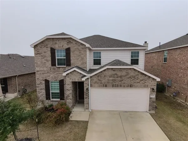 a front view of a house with garage
