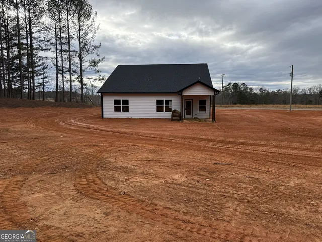 a view of house with yard and entertaining space