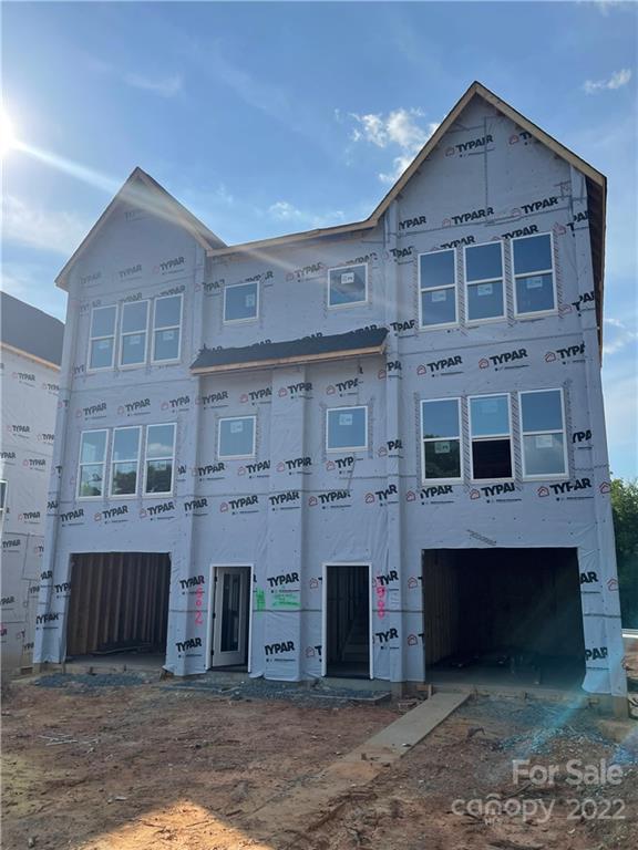 1506 Effingham Road Charlotte, NC 28208 - Photo 1 of 8 a view of a big room with windows and a fireplace