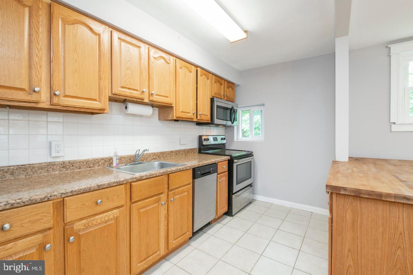 763 Humphreys Road Ardmore, PA 19003 - Photo 11 of 28 a kitchen with stainless steel appliances granite countertop a sink stove and cabinets