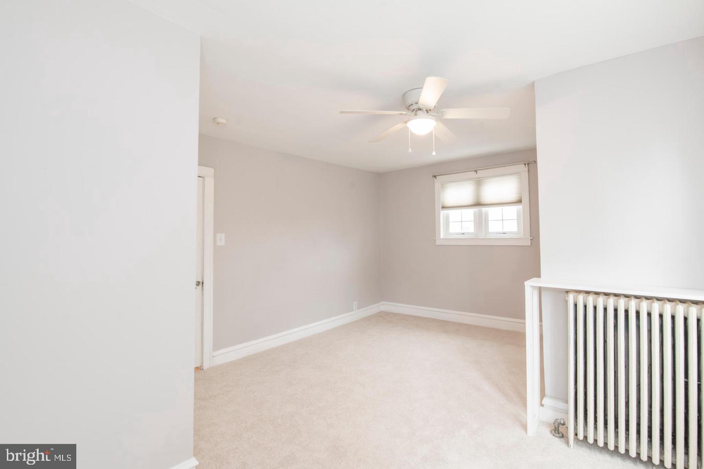 763 Humphreys Road Ardmore, PA 19003 - Photo 13 of 28 an empty room with a window and a fan