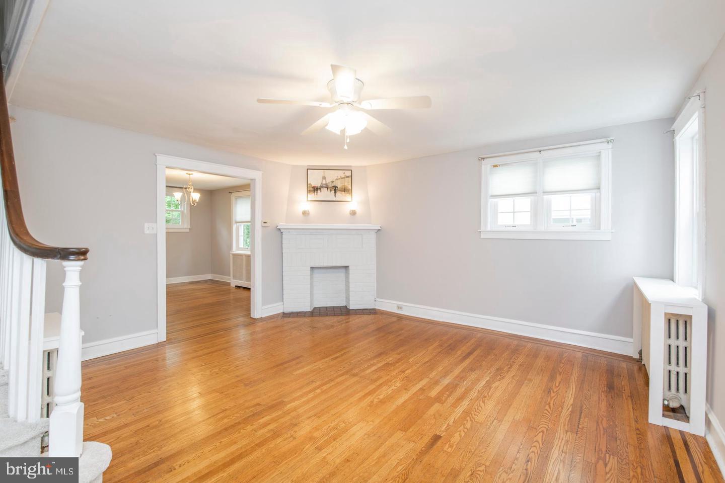 763 Humphreys Road Ardmore, PA 19003 - Photo 5 of 28 an empty room with wooden floor fan and windows