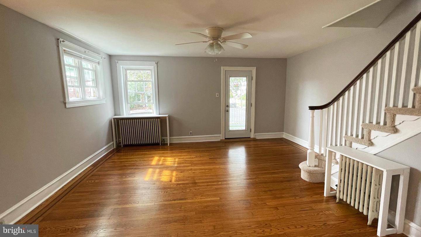 763 Humphreys Road Ardmore, PA 19003 - Photo 7 of 28 a view of an empty room with wooden floor and a window