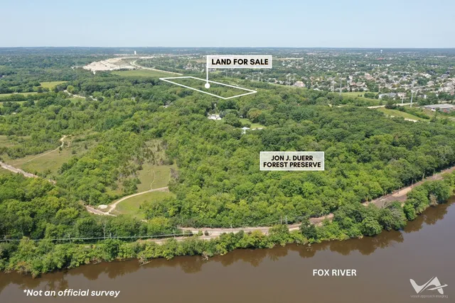 an aerial view of residential houses with outdoor space and river