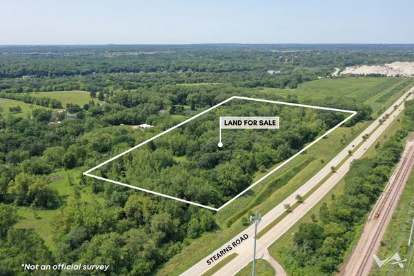 an aerial view of residential houses with outdoor space and trees