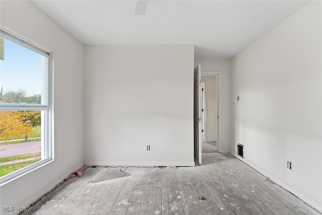 1206 Diagonal Road Akron, OH 44320 - Photo 19 of 28 Empty room with hardwood / wood-style floors and ceiling fan