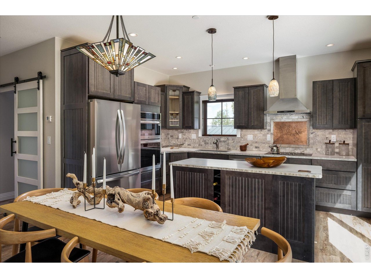 713 Rudi Lane Golden, CO 80403 - Photo 12 of 49 a kitchen with stainless steel appliances kitchen island granite countertop a sink refrigerator and cabinets