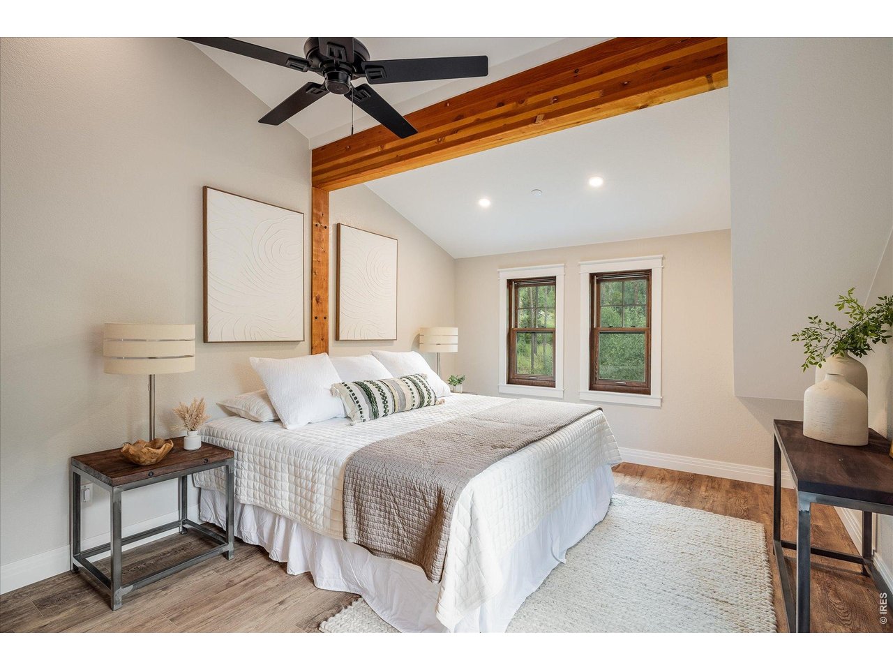 713 Rudi Lane Golden, CO 80403 - Photo 25 of 49 a bedroom with a bed a lamp and window