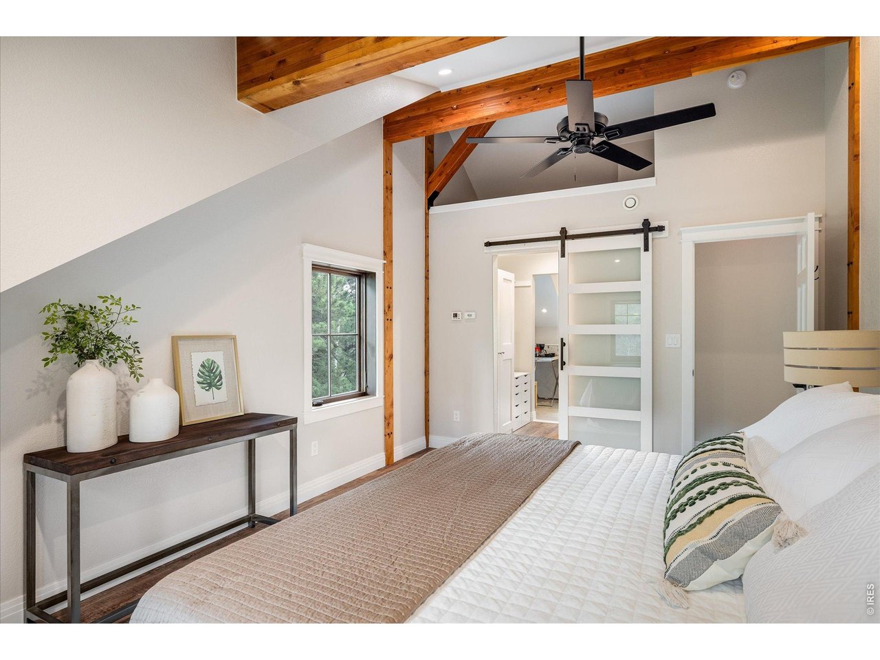 713 Rudi Lane Golden, CO 80403 - Photo 26 of 49 a bedroom with a bed and a potted plant