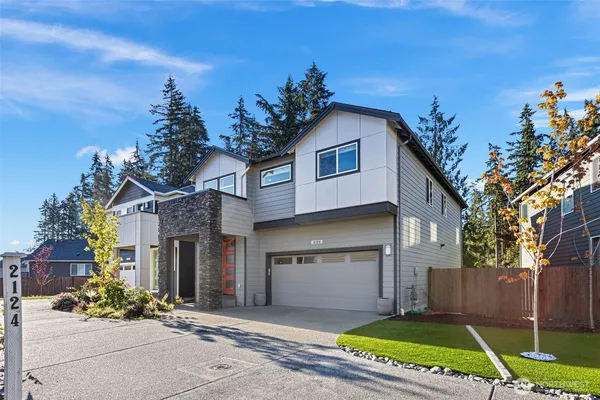 a front view of a house with a yard and garage
