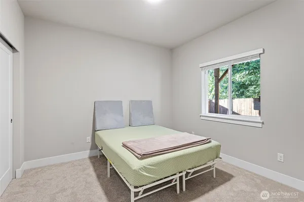 a bedroom with a bed and a window