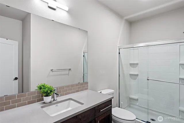 a bathroom with a sink toilet and shower