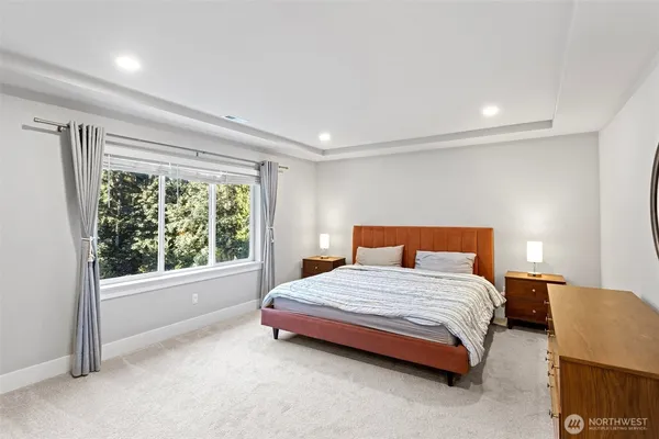 a bedroom with a bed and a large window