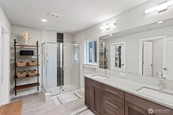 a spacious bathroom with a shower sink and mirror